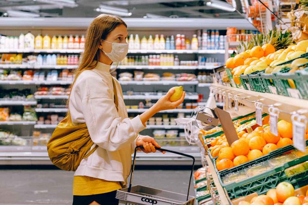 Image of a woman buying groceries.
